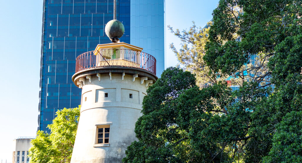 The Old Windmill in Wickham Park with city skyscrapers in the background