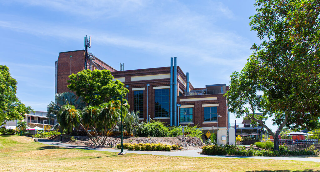 Historic Powerhouse Brisbane surrounded by greenery and riverside paths