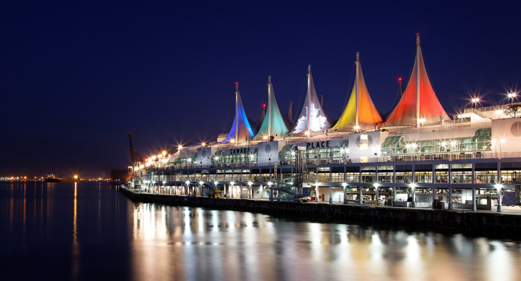 Colorful sails of Canada Place reflecting on Vancouver’s harbor waters