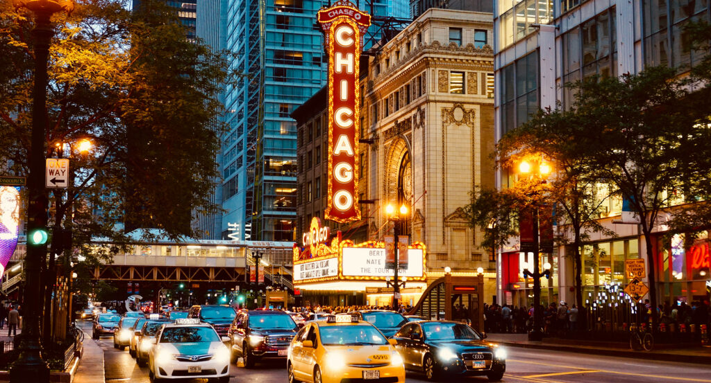 Ornate grand hall interior of Chicago Theatre with chandeliers and arches