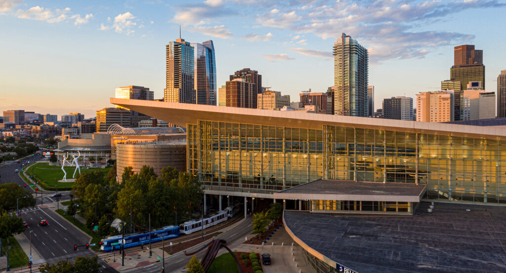Glass facade of Colorado Convention Center with Denver skyline