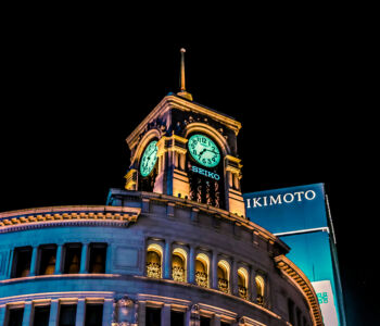 Wako clock tower illuminated at night in Ginza Tokyo