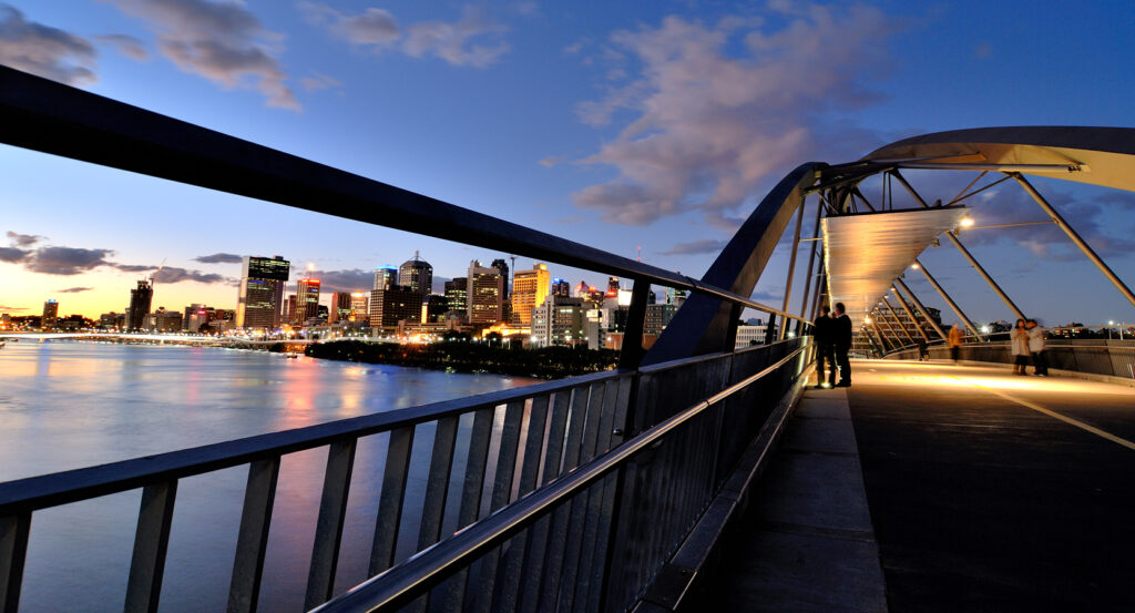 Evening view of Goodwill Bridge lit up with Brisbane skyline in the background
