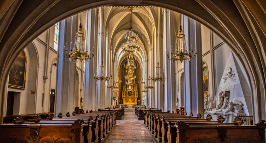 Gothic arches and pews inside Augustinerkirche Zurich