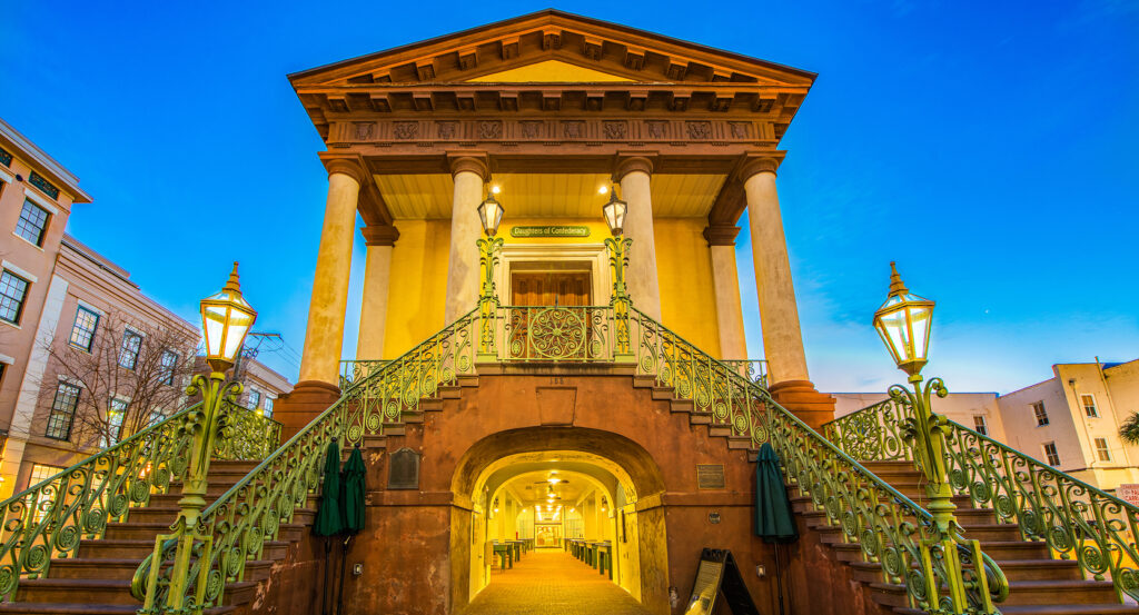 Historic Charleston City Market with lights glowing in evening