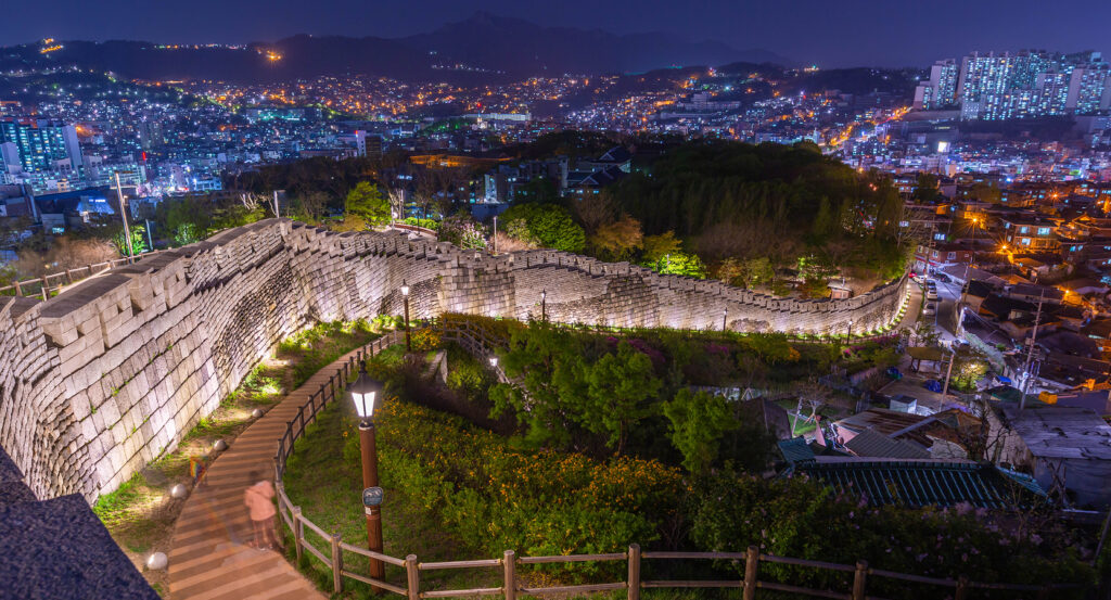 Scenic view of Naksan Park wall glowing above Seoul city lights
