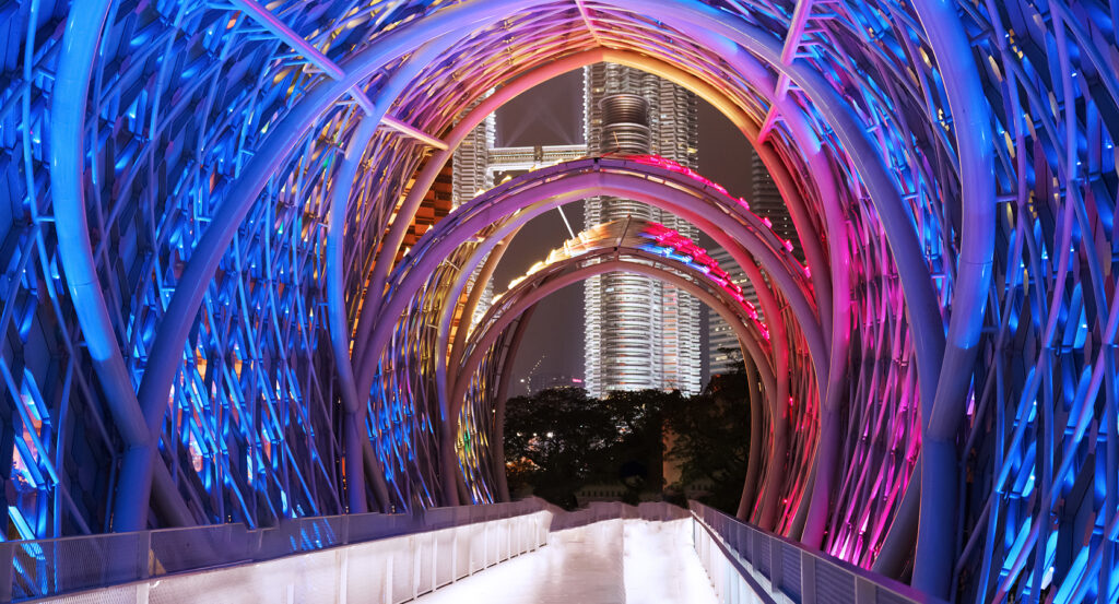 Saloma Bridge glowing with vibrant lights against KL skyline