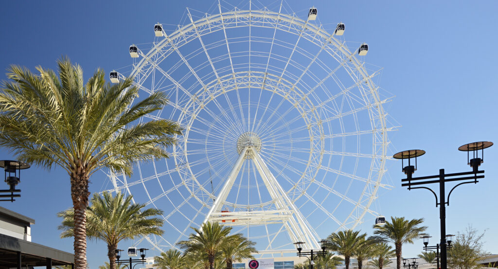 Sunset lights reflecting over restaurants and attractions on International Drive in Orlando