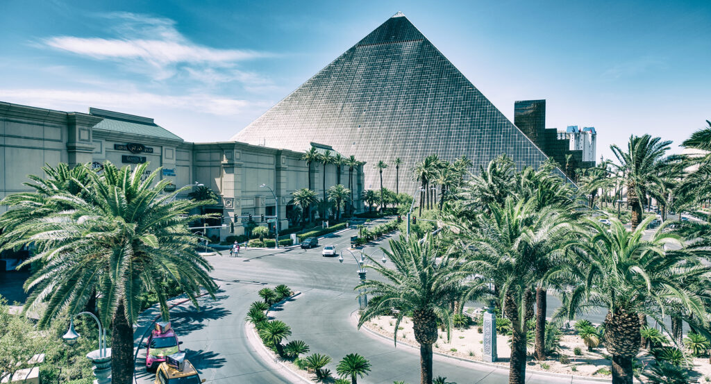 Exterior view of Luxor Hotel and Casino with palm trees in Las Vegas