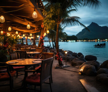 Sunset view over Matira Beach in Bora Bora with glowing lanterns and lagoon backdrop