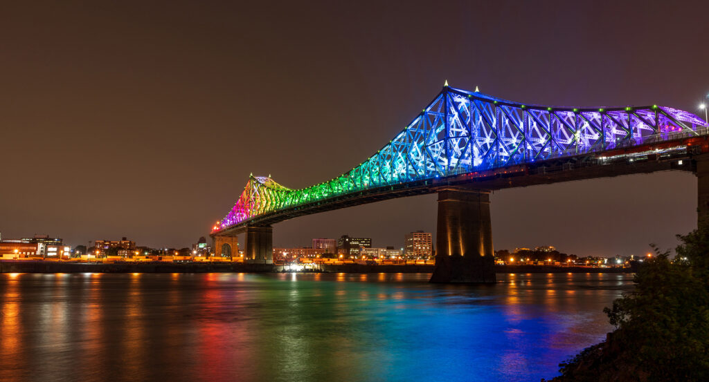 Illuminated Jacques Cartier Bridge reflecting on the St. Lawrence River