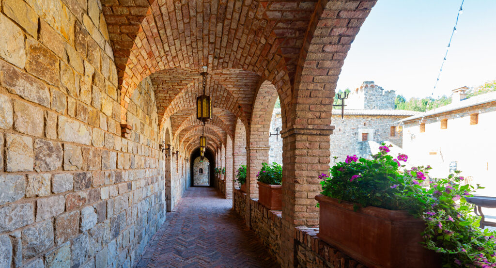 Exterior view of Castello di Amorosa winery surrounded by vineyards