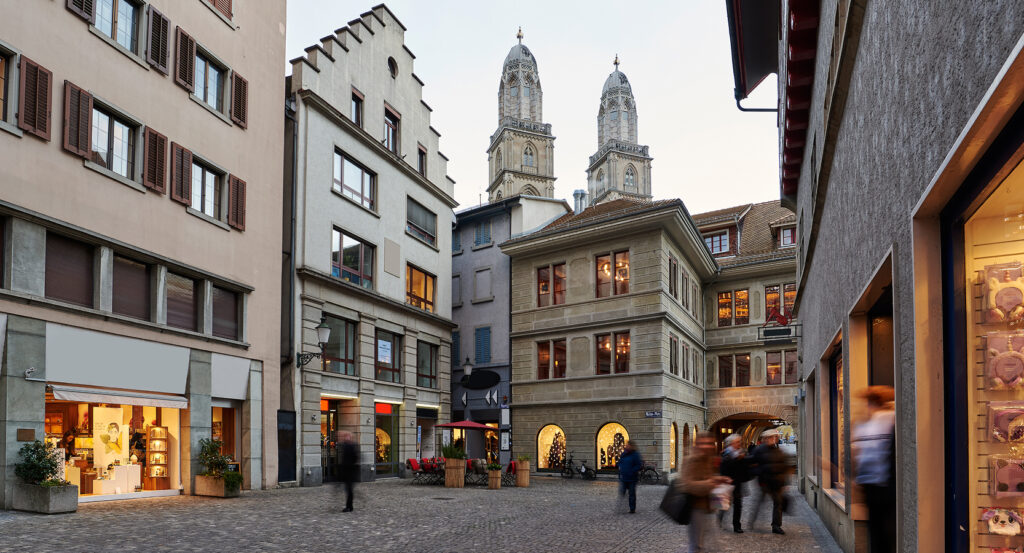 Night view of Niederdorf near the Limmat with Grossmunster towers lit