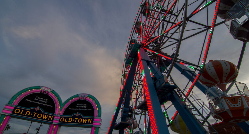 Classic cars and neon lights along the main street in Old Town Orlando