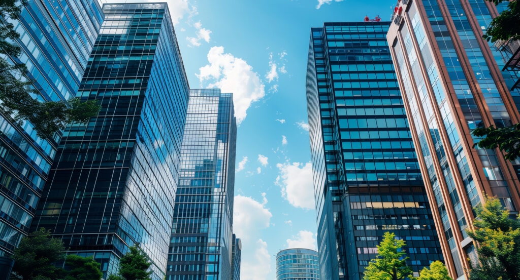 Street-level view of Otemachi towers with trees and sunlight in Tokyo