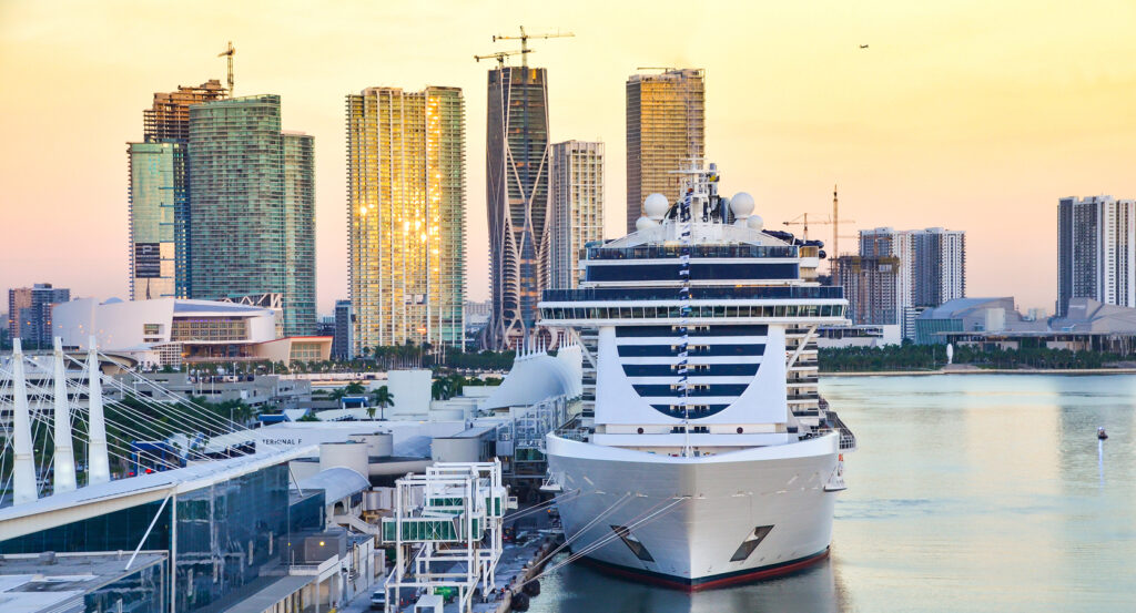 Sunset skyline view over Port of Miami with ships and modern high-rise buildings