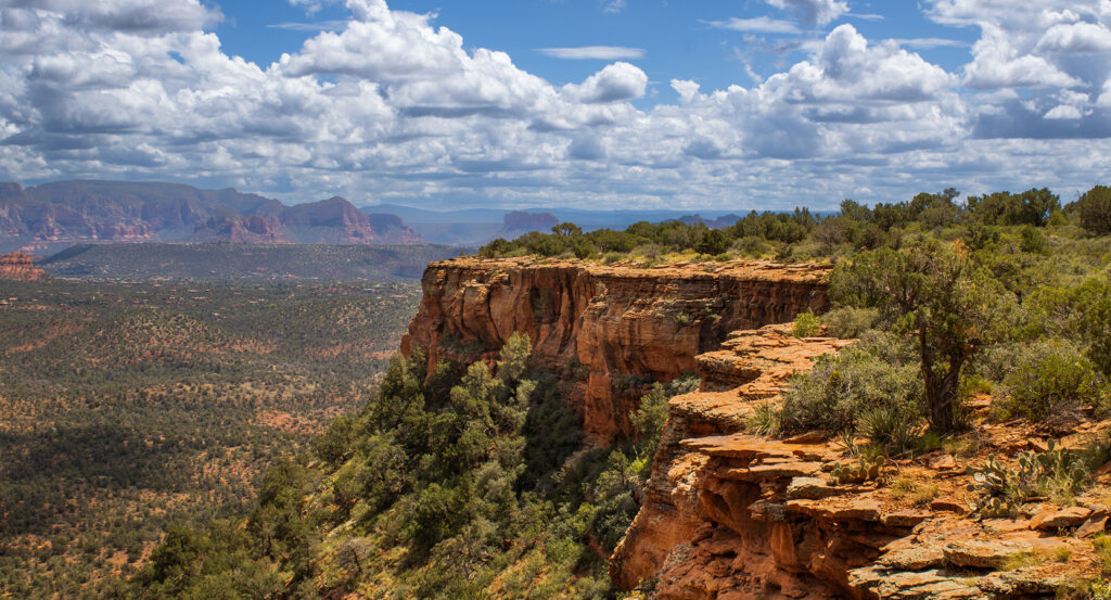 Panoramic vista from the flat mesa top of Doe Mountain overlooking Sedona's red rocks