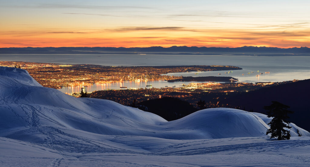 Panoramic view from Mount Seymour overlooking city lights and ocean