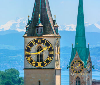 St Peter’s Church clock tower with Alps in background