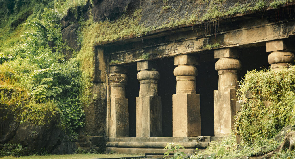 Entrance of Elephanta Caves surrounded by greenery