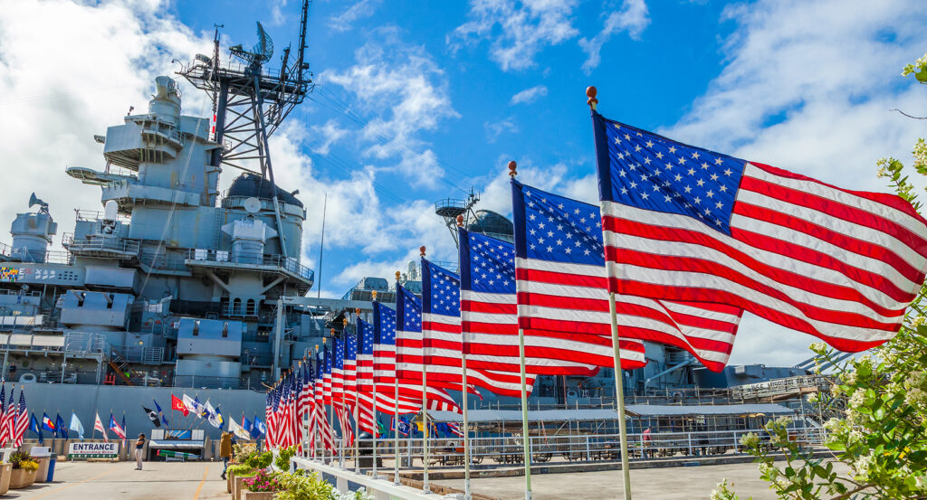 USS Arizona Memorial with rows of American flags at Pearl Harbor