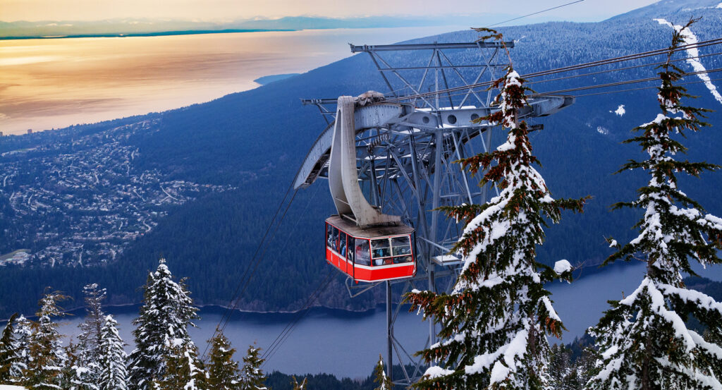 Snow-covered Grouse Mountain overlooking Vancouver and ocean