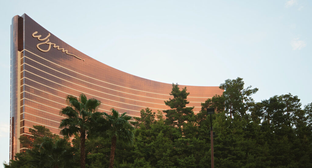 Wynn Las Vegas luxury resort reflecting sunset above lush green landscaping