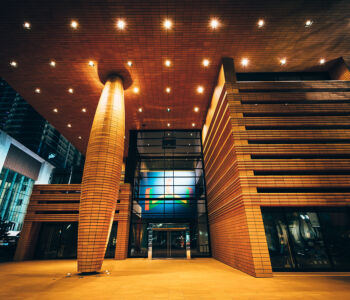 Bechtler Museum of Modern Art exterior at night with dramatic lighting highlighting its sculptural architecture.