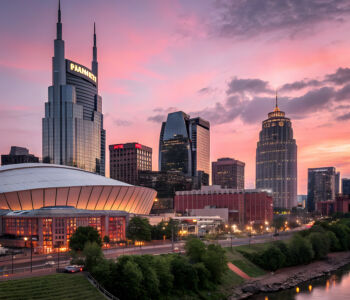 Dusk view of Nashville skyline with Bridgestone Arena and surrounding towers.