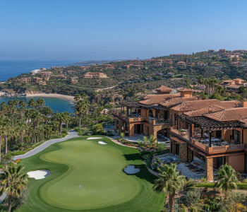 Aerial view of Cabo Real golf course overlooking the coastline and luxury villas.