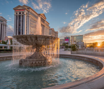 Fountain at Caesars Palace with the Las Vegas Strip skyline at sunset