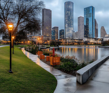 Discovery Green Park with downtown Houston skyscrapers reflected along the wet pathways in Texas.