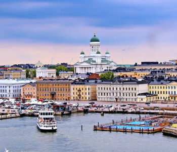 View of Helsinki harbor with boats and the white Helsinki Cathedral in the background