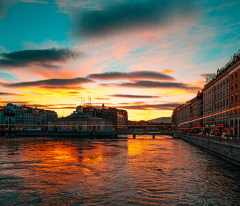 Lake Geneva waterfront at sunset with city buildings