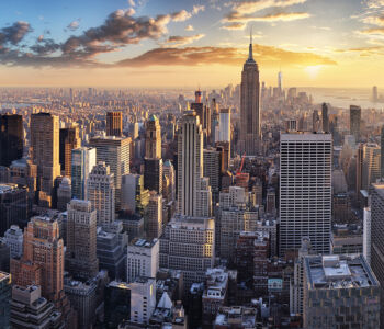 Aerial sunset view of the New York City skyline with the Empire State Building in Midtown Manhattan