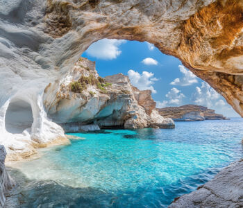 Turquoise water inside Sikia Cave on Milos, viewed through a natural rock opening.