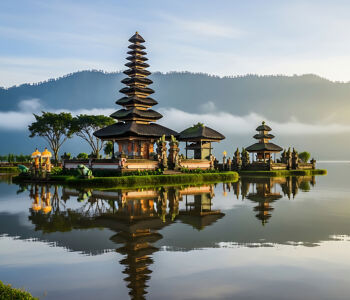 Ulun Danu Beratan Temple at sunrise reflected on still water in Bali