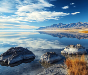 Great Salt Lake in Utah reflecting the surrounding mountains under a bright blue sky
