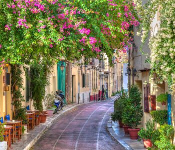 Colorful pedestrian street lined with cafés in Plaka, Athens