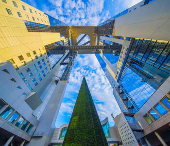 Umeda Sky Building in Osaka, Japan, viewed from below with its circular observatory and mirrored towers
