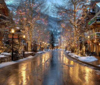 Vail Village Colorado winter street with festive lights and snow covered buildings