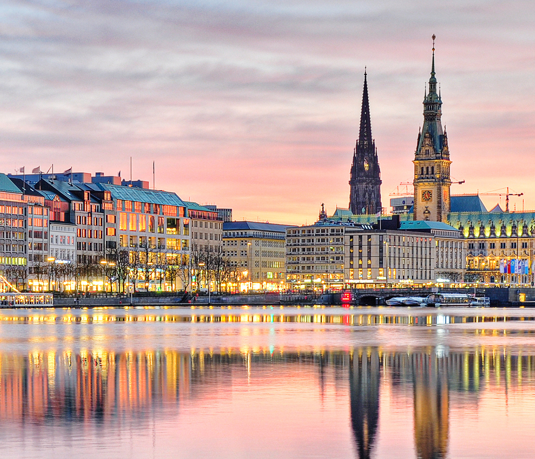 Hamburg skyline reflected on Alster Lake at dusk